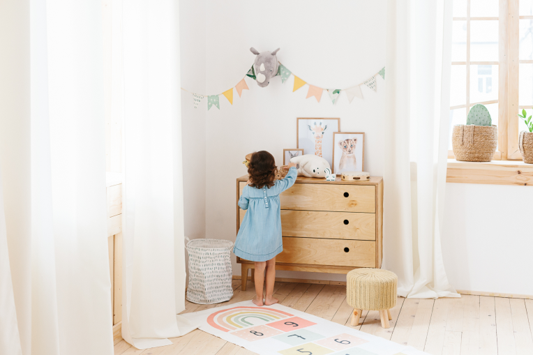 Bedroom with Clever Little Monkey wooden baby furniture and a mother holding her baby